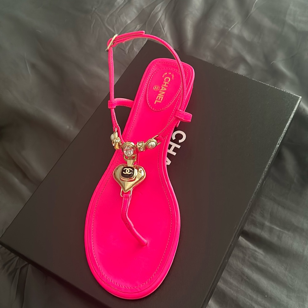 Hot pink Chanel sandals with gold hardware.